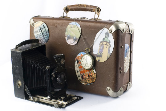 old suitcase, photo camera and clock