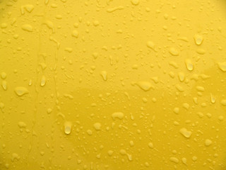 backgrounds: textural: wet yellow painted metal