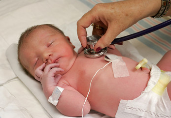 newborn being checked by doctor