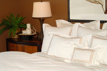 bed with white bedspread and nightstand