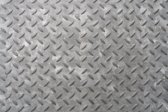 close up of the pattern on a metal manhole cover.