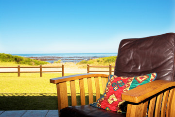 Naklejka na ściany i meble comfortable chair on patio at seaside