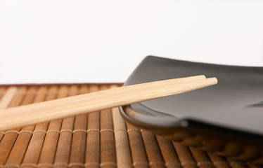 chopsticks on the black plate