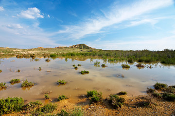 hill over the blue sky and the lake