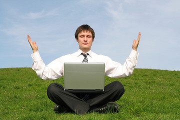 businessman with laptop doing yoga