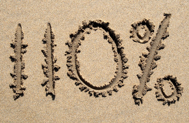 110% written on a sandy beach.