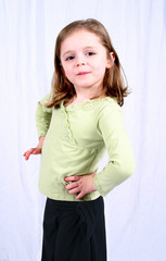 cute little girl sitting on a white background