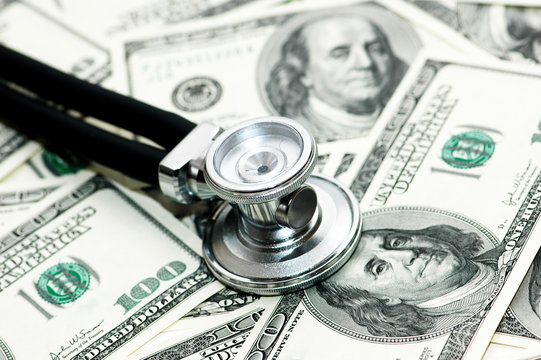 medical concept -  stethoscope over the dollar bills
