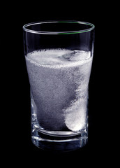 tablet dissolving in a glass of water