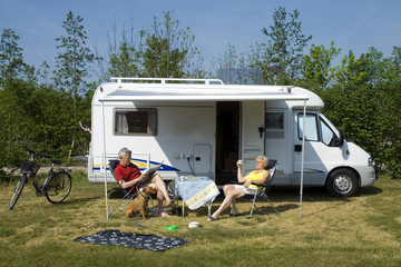 an elderly couple with camper