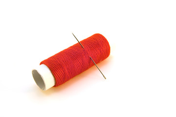 needle and a red thread-closeup