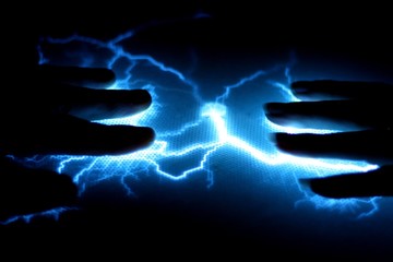 two hands connected by a bolt of electricity