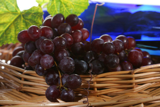 grapes with leaf and wine in a basket