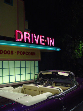 retro drive-in and convertible at night