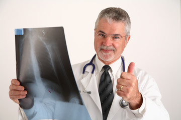 doctor with x-ray giving the thumbs up sign