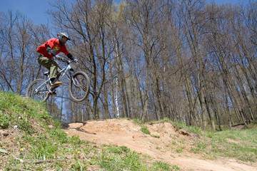 mountain biker jumps from a hill