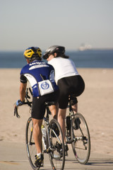 two cyclists along the beach