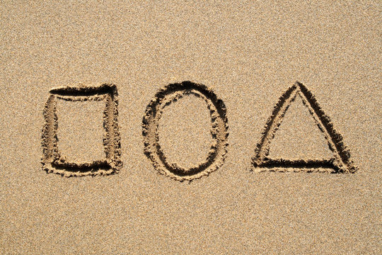 a square, circle and triangle drawn in the sand.