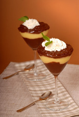 two glasses of chocolate and vanilla pudding