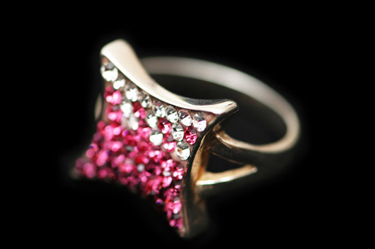 jewel ring with white and pink stones isolated on black