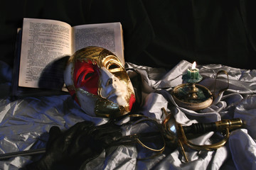 mask.rapier. candle. book
