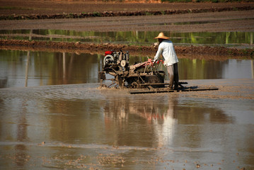 Obraz premium plough machine and farmer