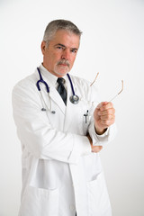 doctor holding eyeglasses explaining