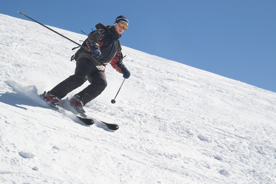 skier with ski pole on snow and blue sky