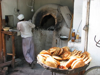 Ouzbékistan - boulanger devant son four et pains traditionnels (Obi-non)