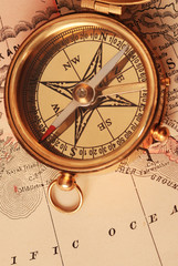 antique brass compass over old map