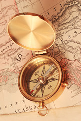 antique brass compass over old map