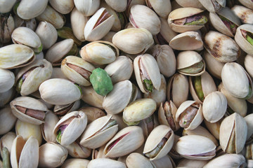 pistachios with a single wasabi pea