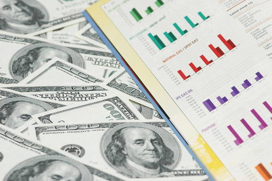 business  bar charts and hundred dollar notes