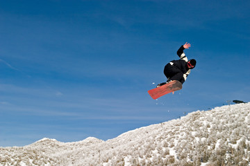 snow boarder high in the air hand