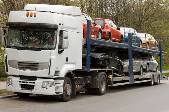 car carrier truck deliver new auto batch to dealer