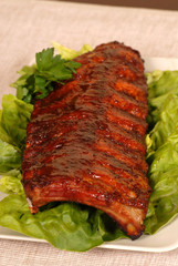 slab of ribs resting on lettuce