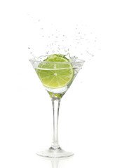 Fototapeta na wymiar lime splashing into a cocktail glass