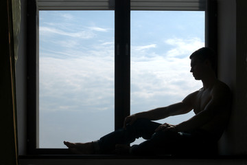 silhouetted man on the windowsill