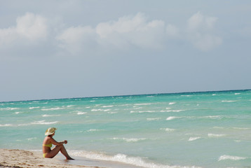 Fototapeta na wymiar woman enjoying solitude on beach