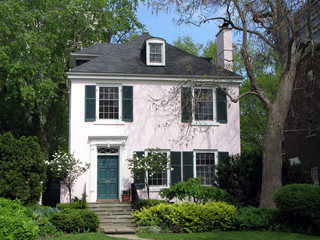 pink stucco house with shady garden