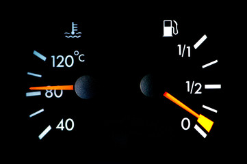 petrol and temperature meters on car dashboard
