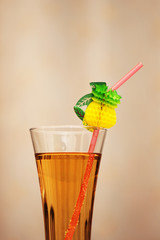 cocktail with the straw against creamy background