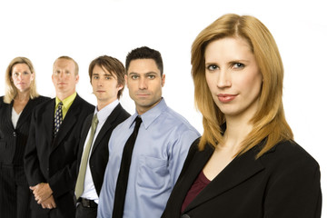 a businesswoman stands confidently with team