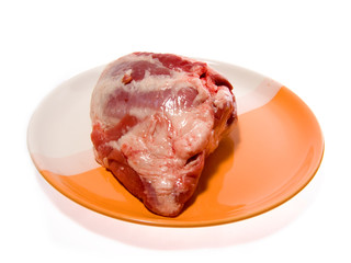 crude meat laying on a dish
