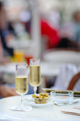 two wine glasses with some olives in a cafe