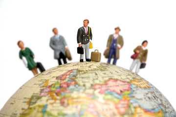 businessmen and businesswomen on a globe