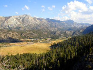 meadow surrounded by mountains
