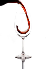 red wine being poured into a glass