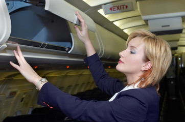 stewardess checking luggage box