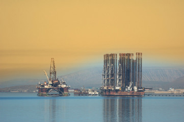 two offshore rigs at caspian shore near baku